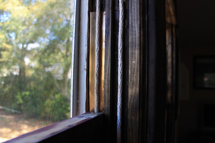 Showing cords, top of the top sash and weather stripping